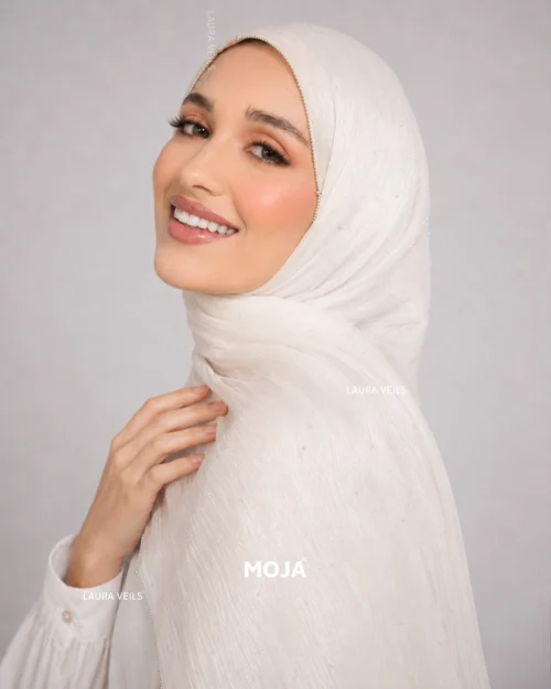 Woman wearing ivory Moja organza shimmer hijab, silver chain lace border, draped instant style