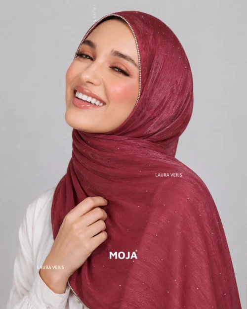 Woman wearing mauve pink Moja organza shimmer hijab, silver chain lace border, draped instant style