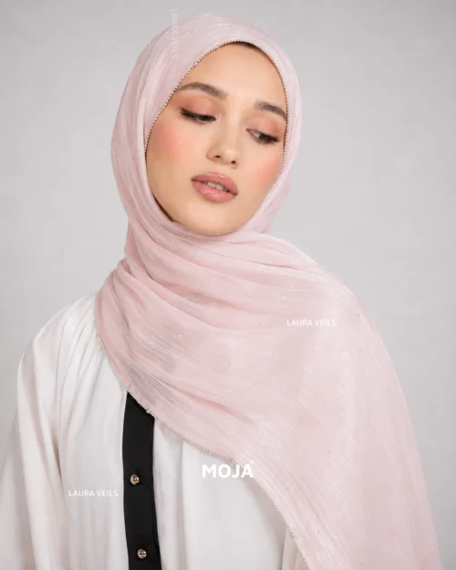 Woman wearing nude pink Moja organza shimmer hijab, silver chain lace border, draped instant style