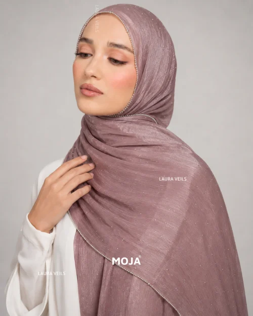 Woman wearing onion Moja organza shimmer hijab, silver chain lace border, draped instant style